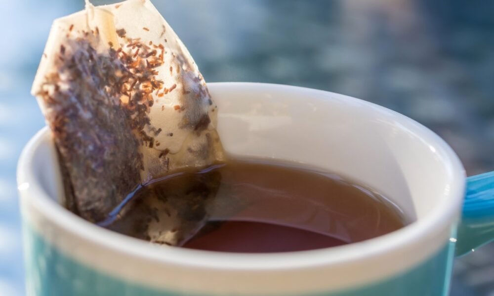 •Image of stainless steel tea infuser with loose-leaf tea. •Picture of silicone tea strainers on a countertop. •Elegant glass tea pot filled with blooming tea leaves.