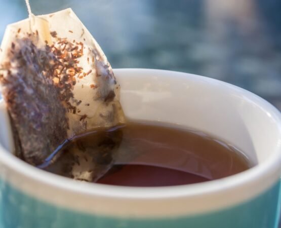 •Image of stainless steel tea infuser with loose-leaf tea. •Picture of silicone tea strainers on a countertop. •Elegant glass tea pot filled with blooming tea leaves.