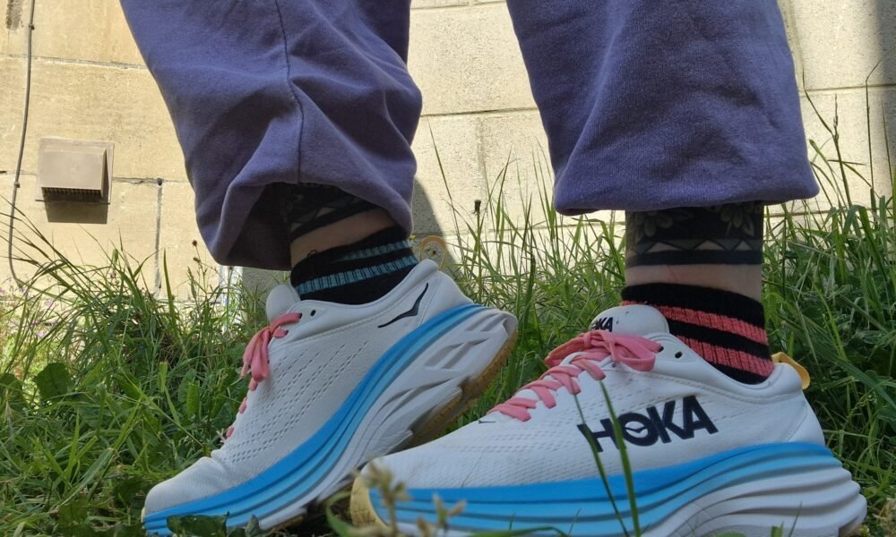 Image of Hoka Bondi shoes on a walking padClose-up of the Hoka Bondi cushioning midsole Active woman walking with Hoka Bondi shoes indoors